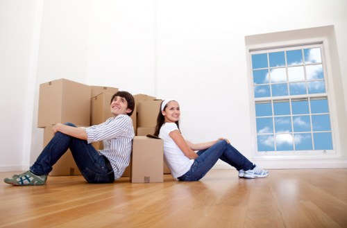 House movers carrying furniture through a flat entrance