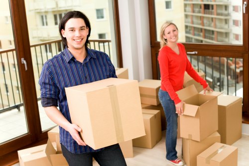 Moving team handling boxes on a Seven Sisters residential street